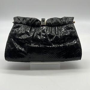 Black skin clutch with gold colored closure